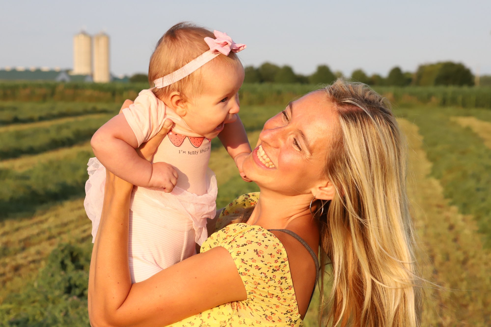 Ania, portrait photographer at Elmira Photography, with baby in Elmira Ontario fields
