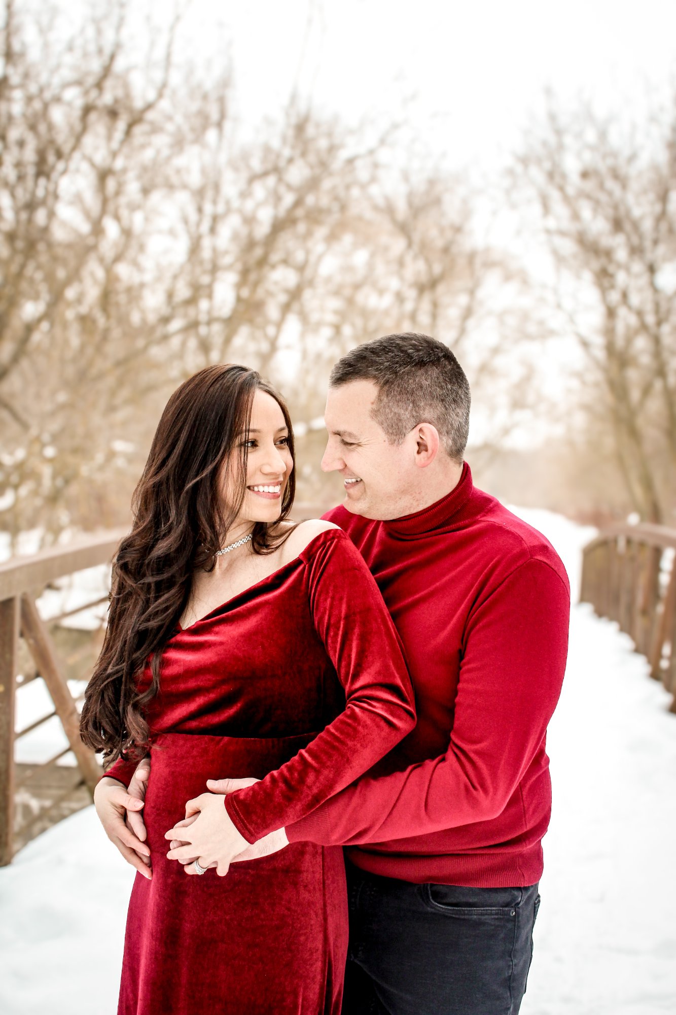 Maternity winter portrait on snowy bridge in Elmira, Ontario