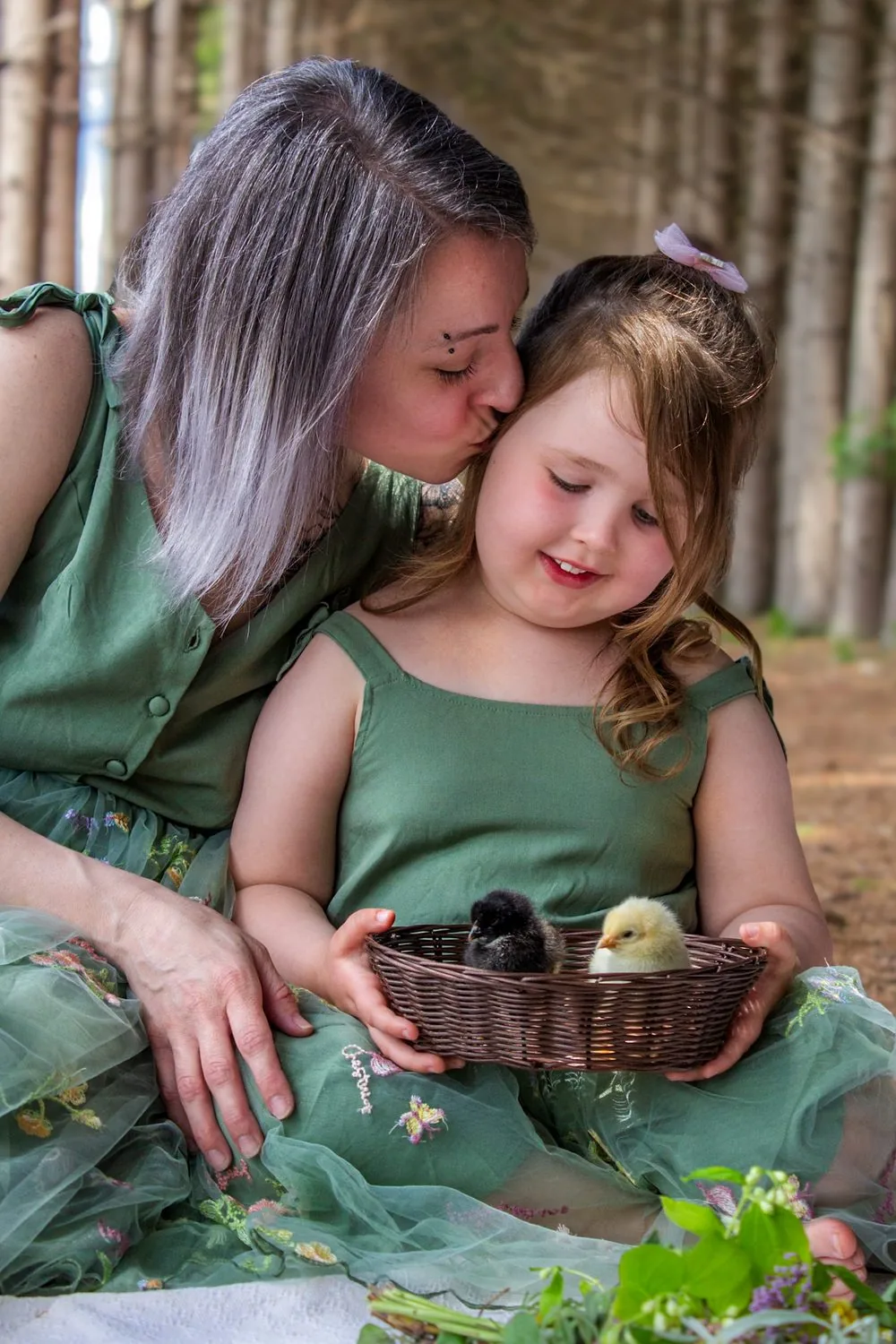 Mother kissing her daughter who is holding a basket of baby chicks - Spring Minis in Elmira, Ontario